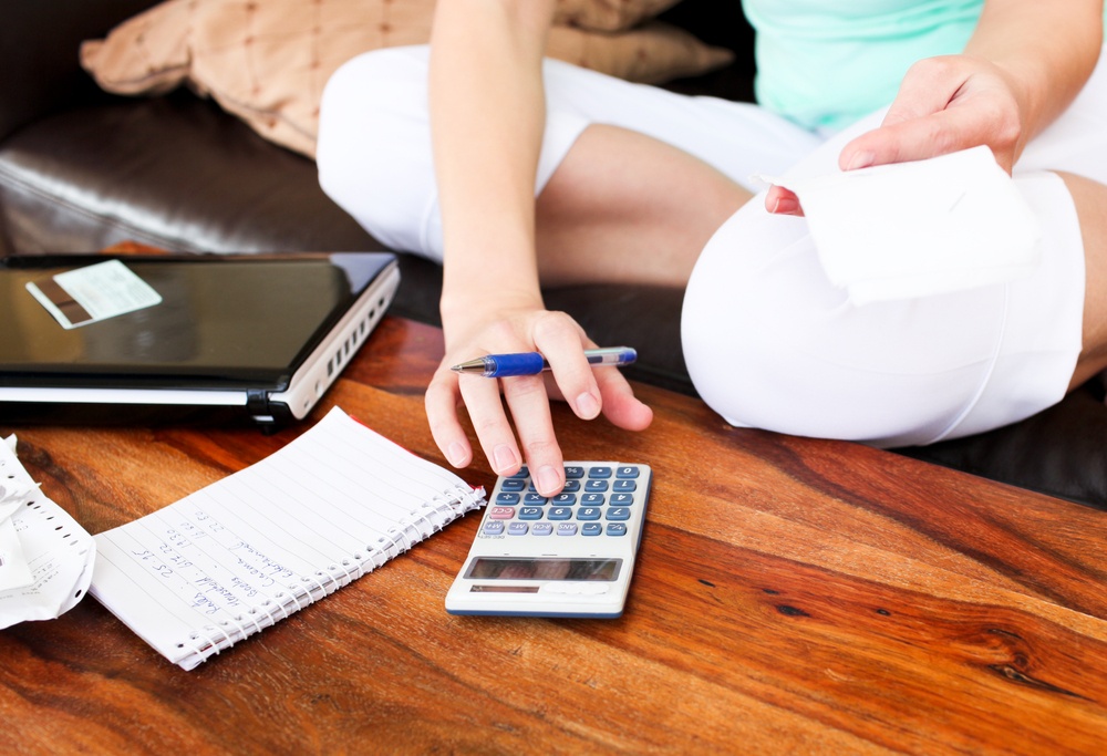 Beautiful woman doing accountancy at home