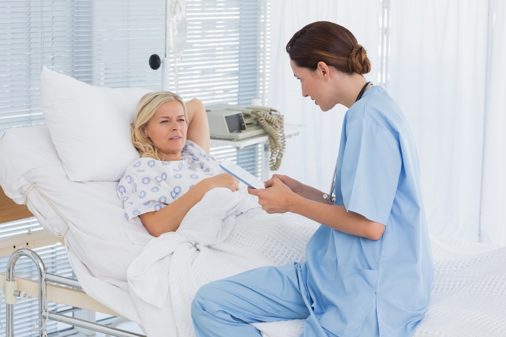 Doctor taking care of patient in hospital room