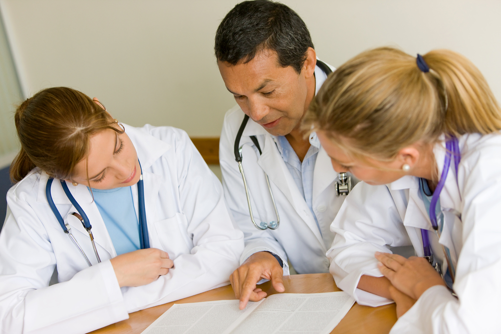 small group of doctors in a meeting discusing a medical history